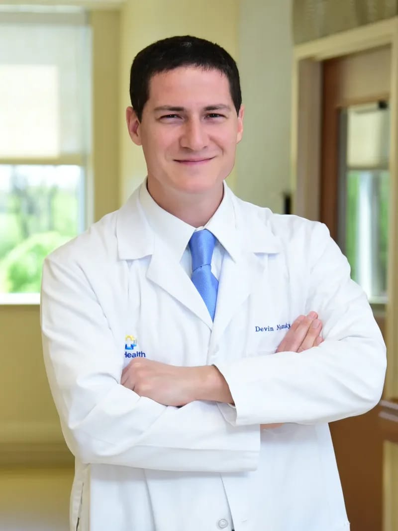 Dr. Devin Namaky, MD — Cincinnati OB-GYN in his white lab coat